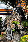 Bangkok Wat Pho, miniature mountain covered in statues of rishis (hermits) demonstrating various positions of healing massage. 